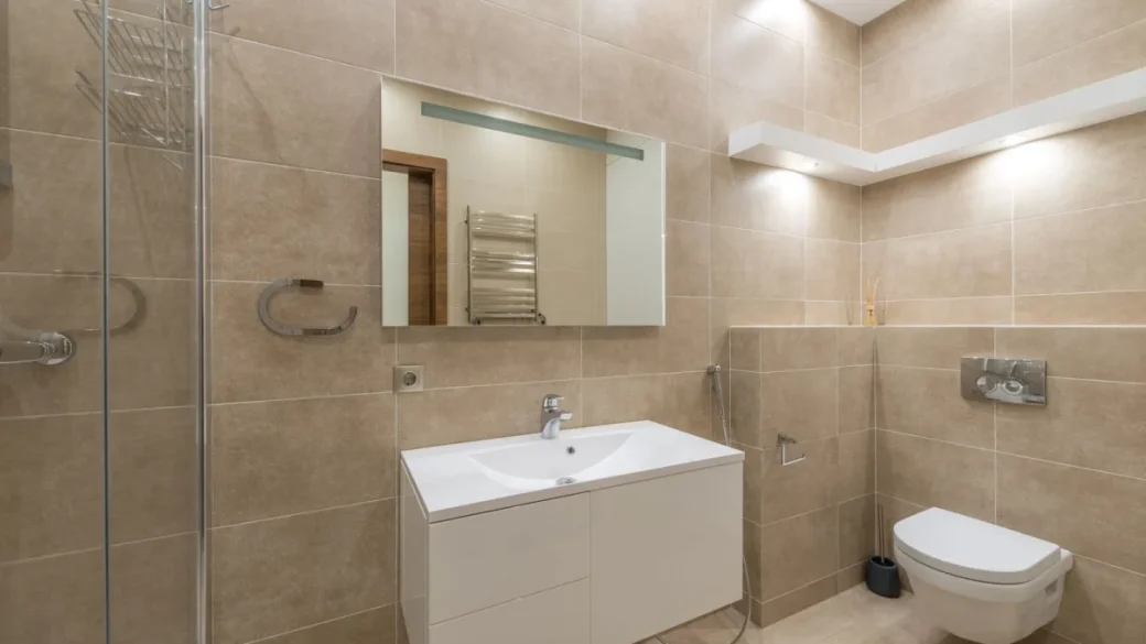 Wiping the warm group head and shower screen with a damp microfiber cloth
