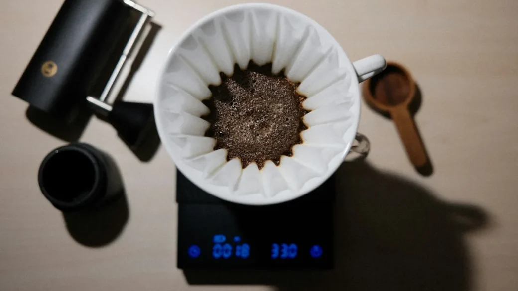 A dosed portafilter basket sitting on a scale reading 18 grams
