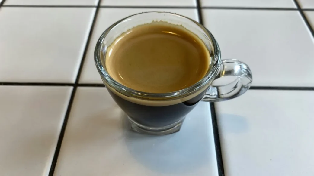 A layer of golden-brown crema sitting on a freshly pulled espresso