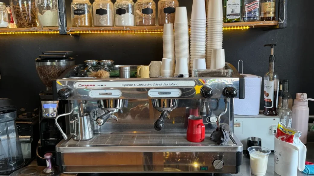 A ULKA vibratory pump mounted inside an espresso machine chassis