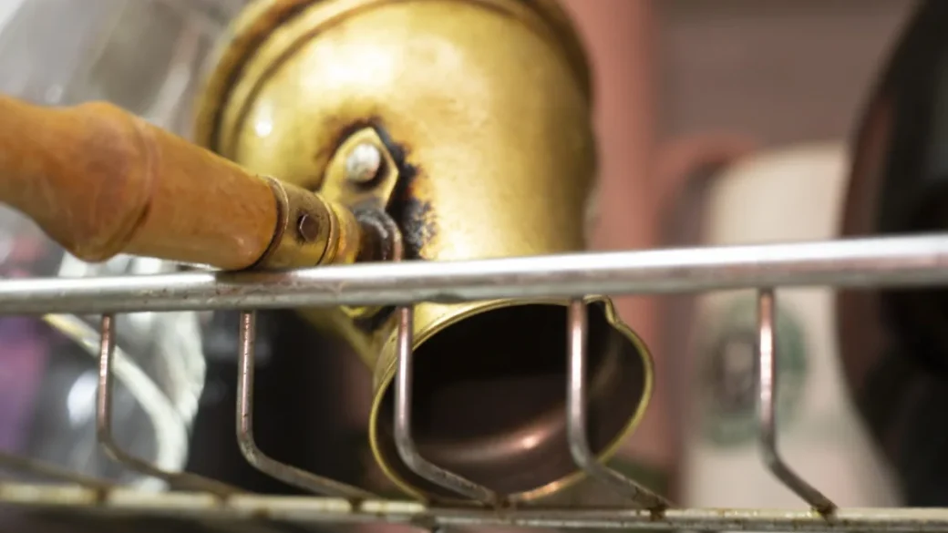 A blind portafilter fitted with a brew pressure gauge reading nine bars