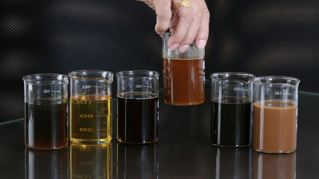 A glass of brewing water next to a freshly pulled espresso shot
