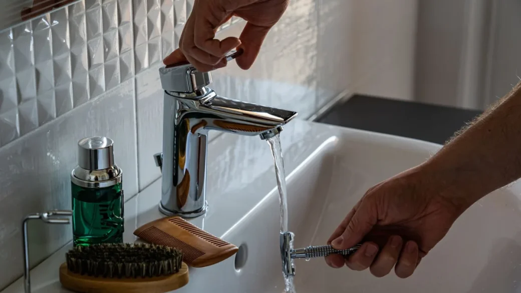 Scrubbing the shower screen and group head with a nylon brush