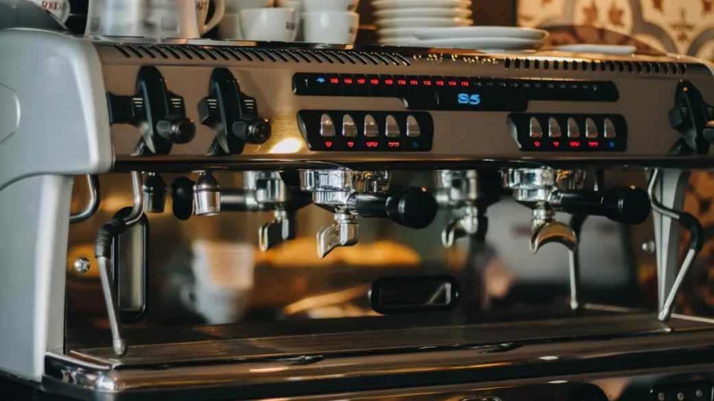 Espresso group head opened up showing the gasket and shower screen