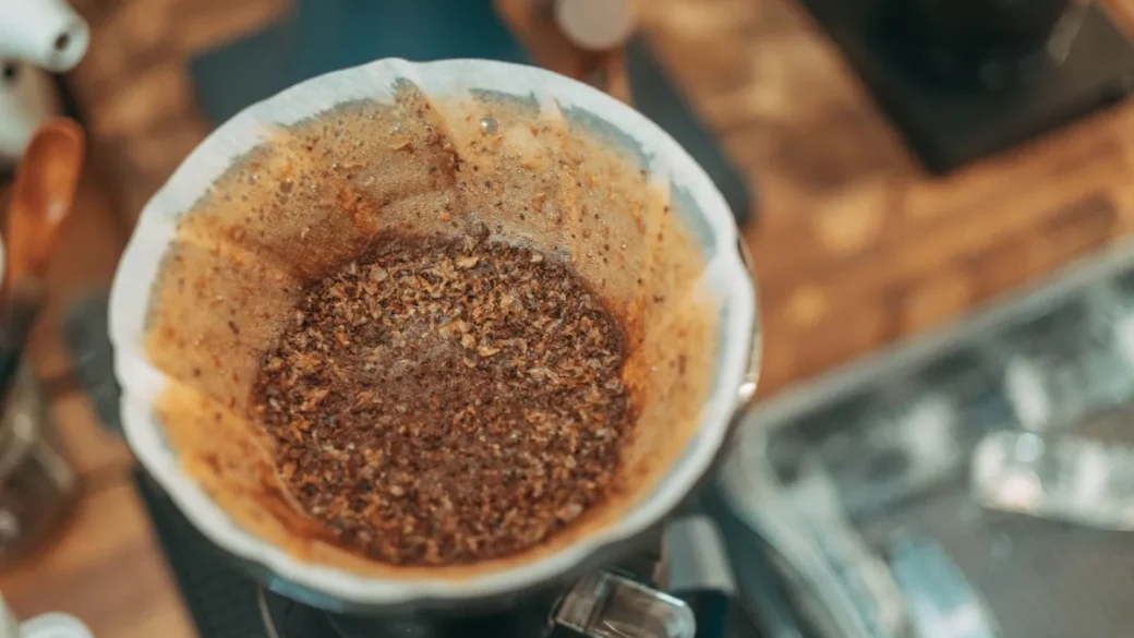 Static-charged grind clumps sitting in a portafilter before distribution