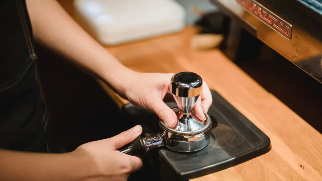 Tamping a level, firm coffee bed to keep the puck intact during pressure release