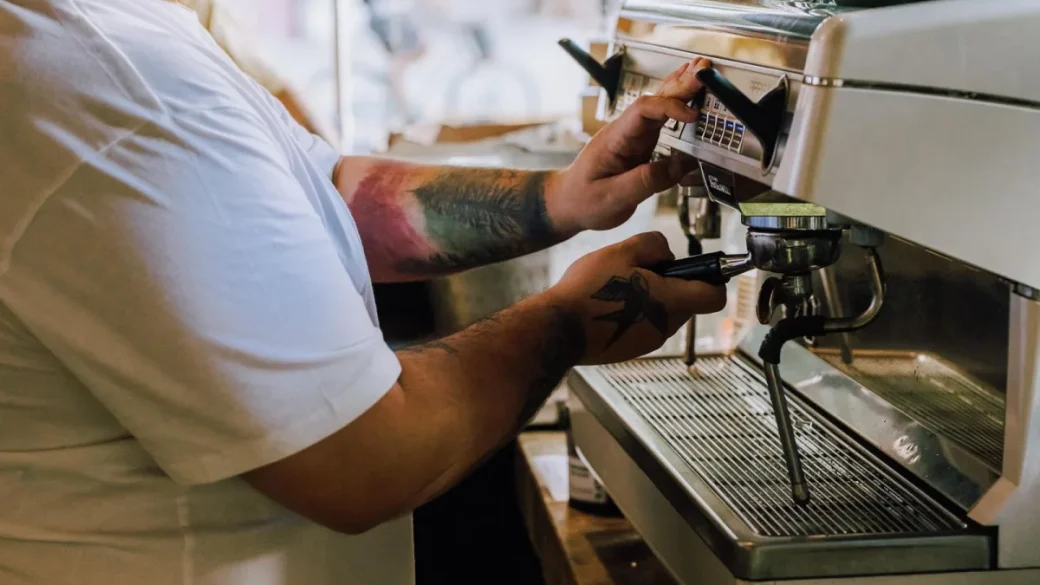 Tamping a level puck of ground coffee in the portafilter