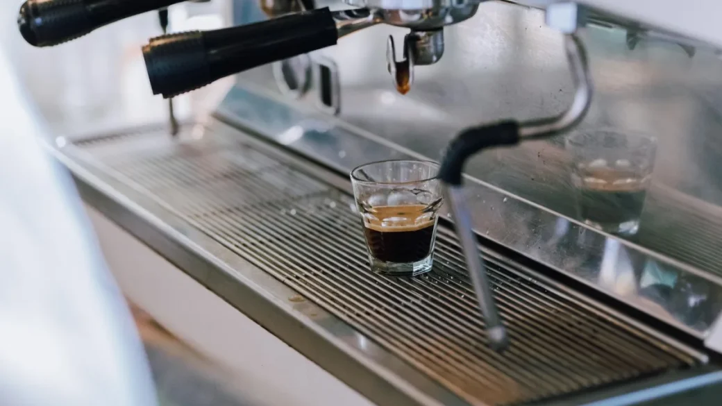 Water dripping from the tip of an espresso steam wand